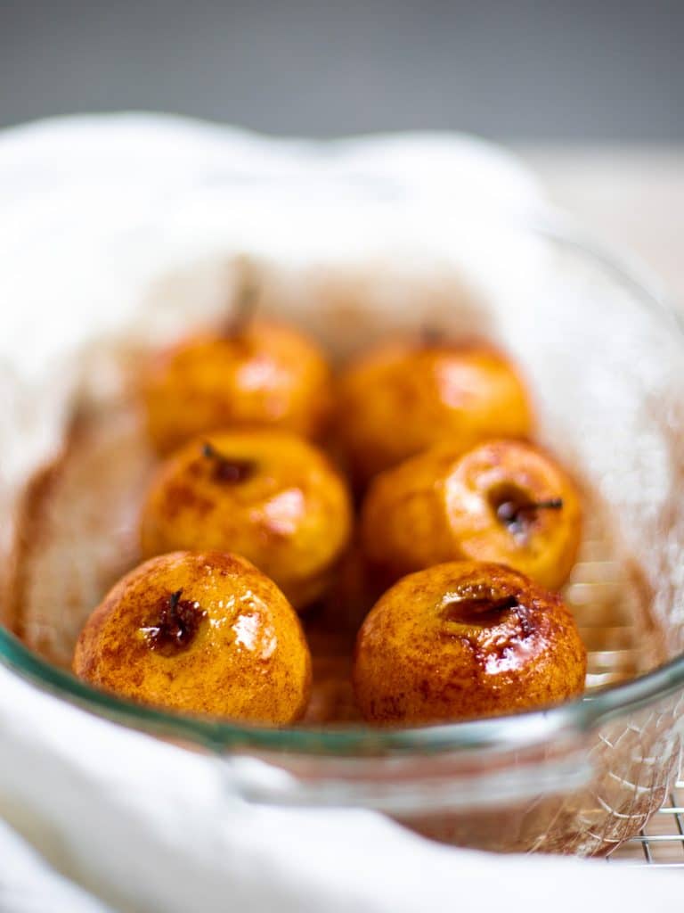 6 baked cinnamon apples in a baking dish