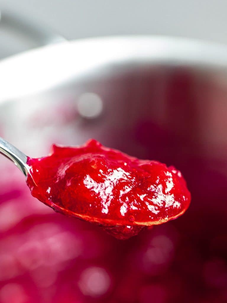 homemade cranberry sauce with maple syrup on a spoon