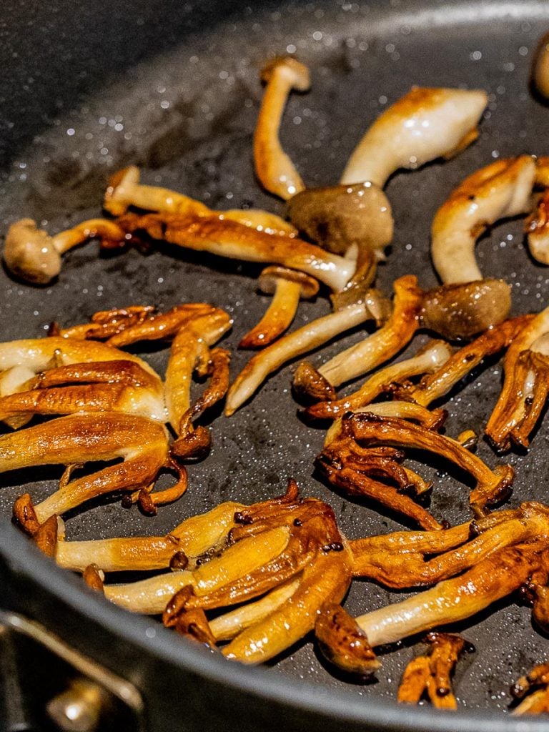 shimeji mushrooms cooking in a pan