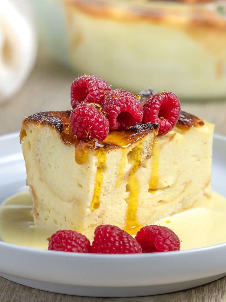 custard bread pudding with raspberries and caramel syrup