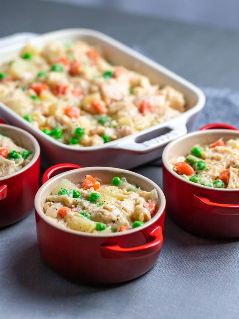 easy chicken pot pie filling in red ramekins and casserole dish
