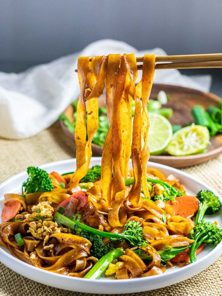 pad see ew thai noodles on chopsticks with vegetables