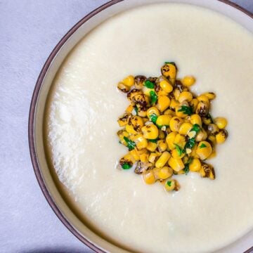 sweet corn soup in a bowl topped with corn kernels