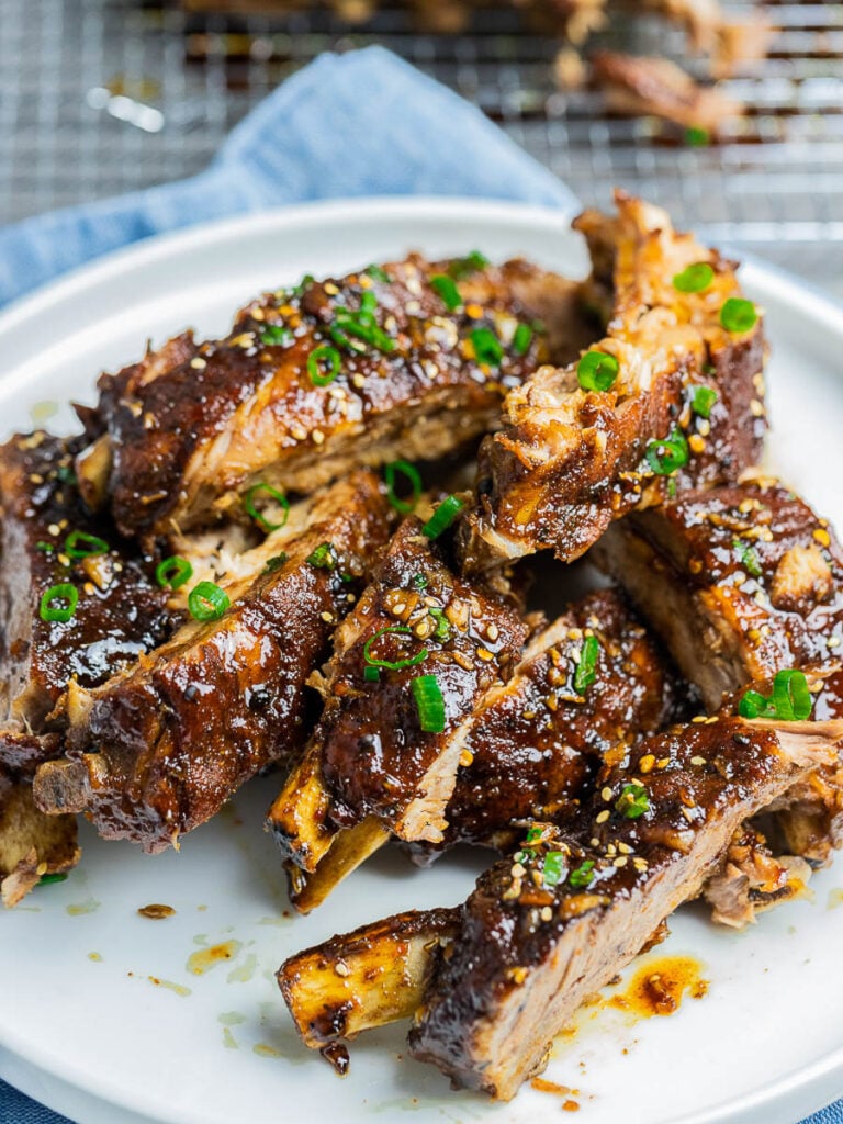 Instant Pot Asian Ribs on a white plate garnished with scallions