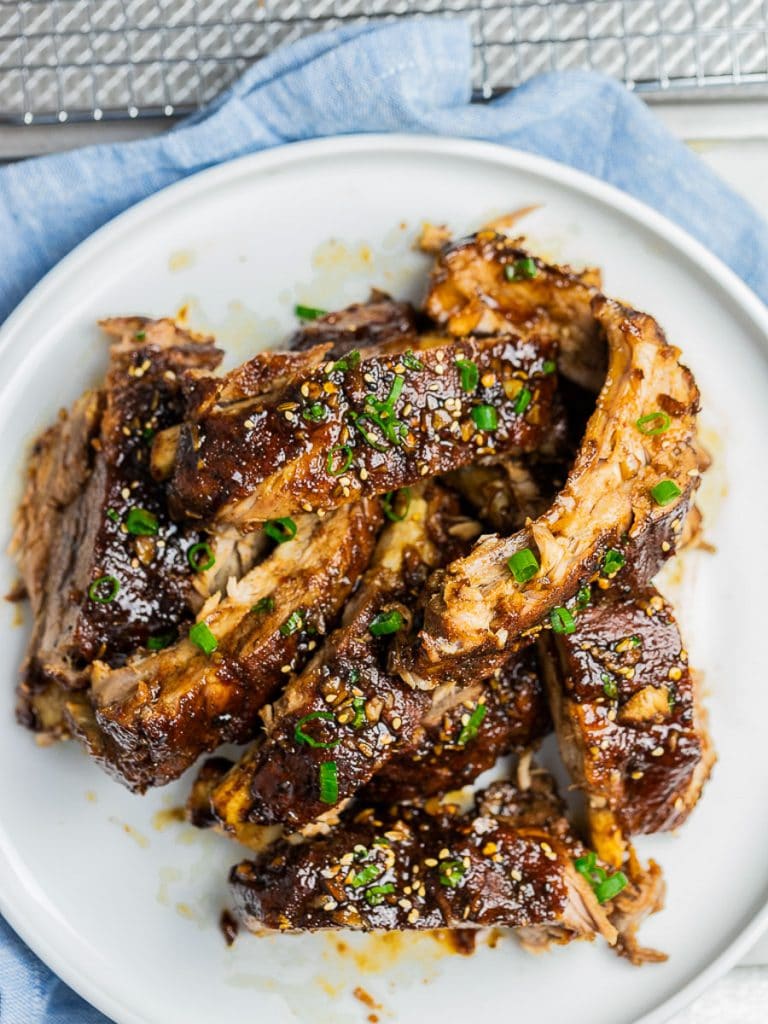Instant Pot Asian ribs on a white plate garnished with scallions