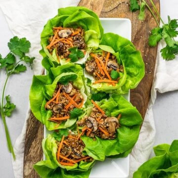PF Chang's vegetarian lettuce wraps with tofu, mushrooms, carrots, and lettuce on a wooden board