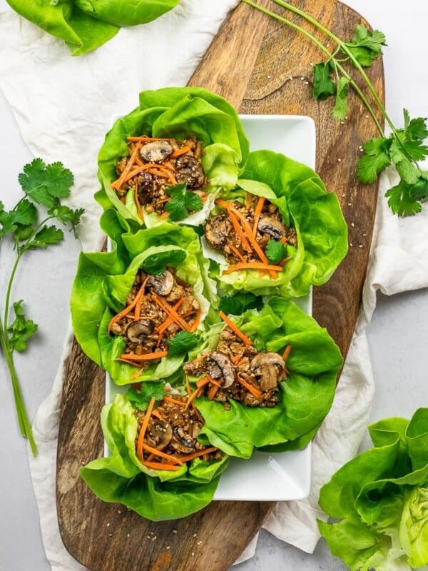 PF Chang's vegetarian lettuce wraps with tofu, mushrooms, carrots, and lettuce on a wooden board