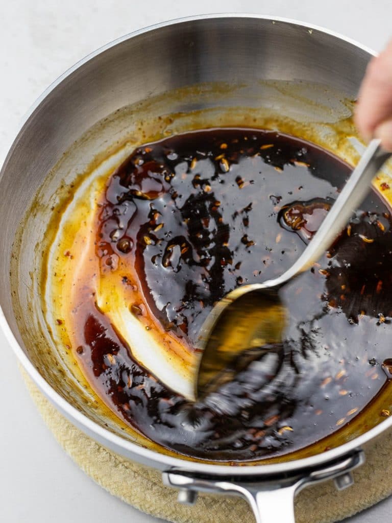 Sweet and tangy soy glaze in a pot with a spoon