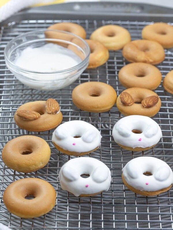 Easter bunny donuts with white candy melt on top of a cooling rack