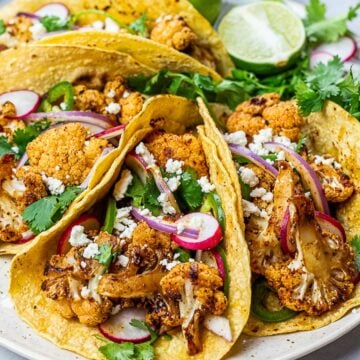 roasted chipotle cauliflower tacos with lime, radish, jalapenos in corn tortillas