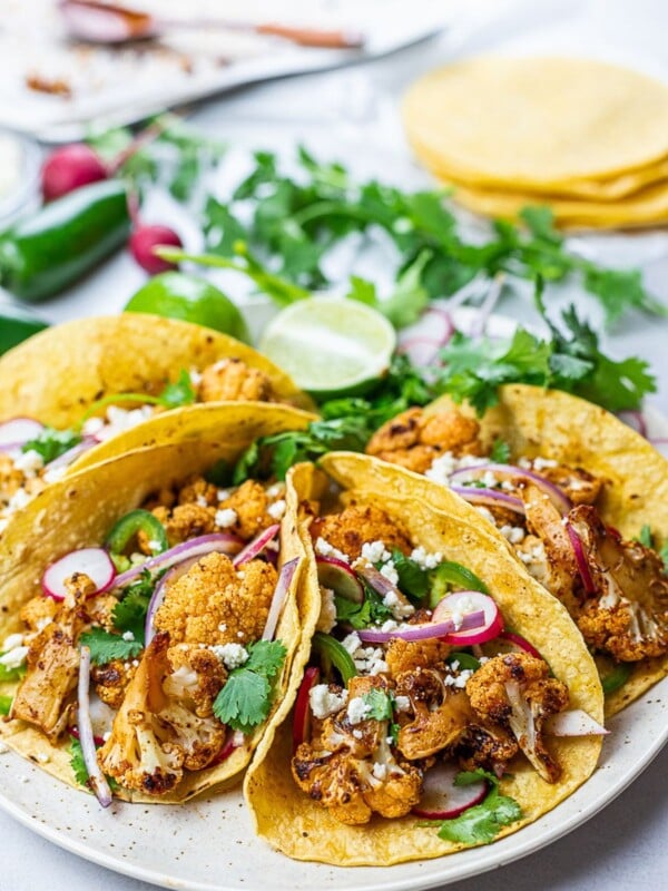 roasted chipotle cauliflower tacos with lime, radish, jalapenos in corn tortillas