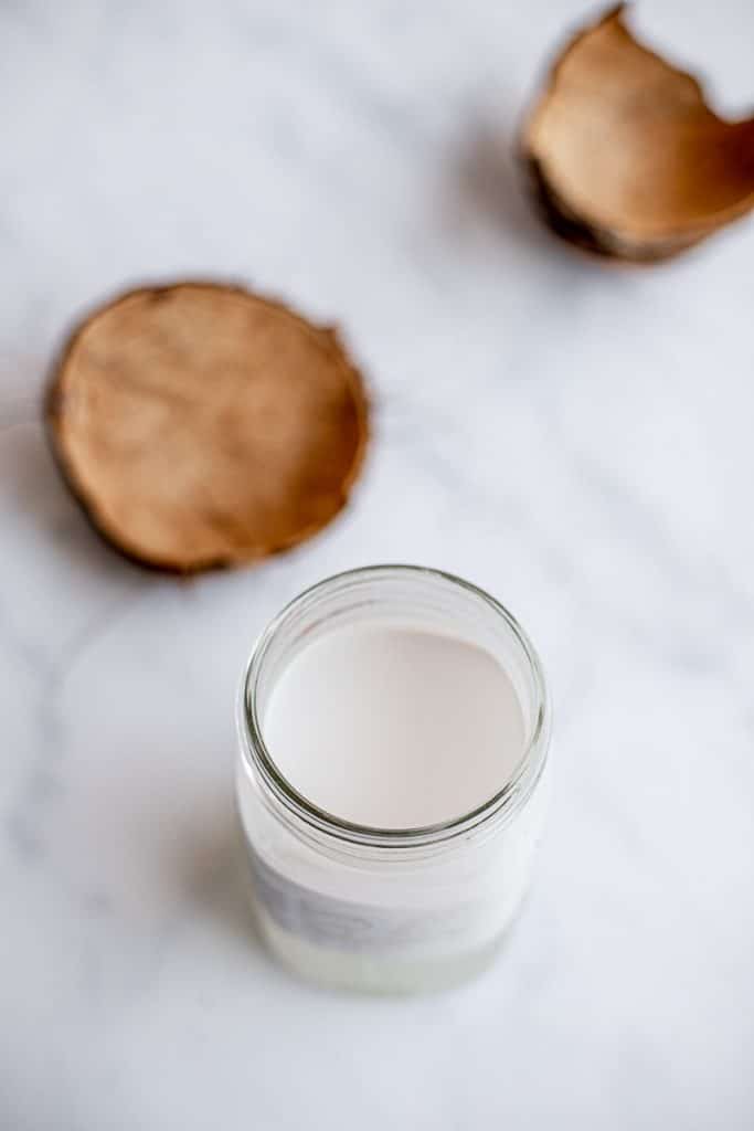 homemade coconut milk in a mason jar with coconut shells