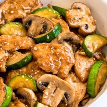Panda Express Mushroom Chicken stir fry with zucchini in a white bowl