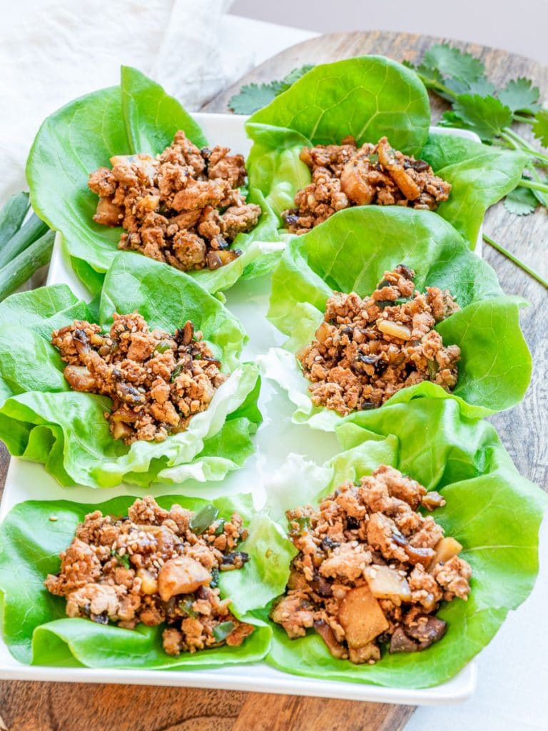 PF Chang's inspired chicken lettuce wraps on a wooden board