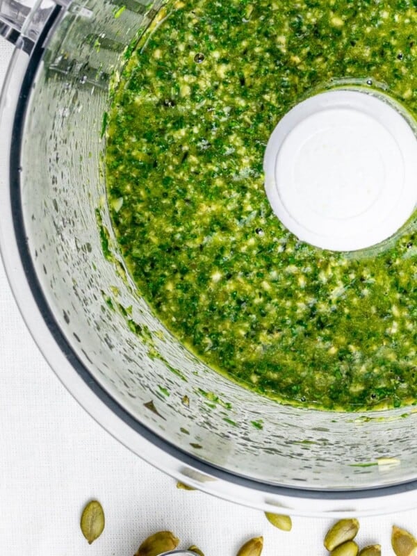vegan pumpkin seed pesto with parsley and basil in a food processor