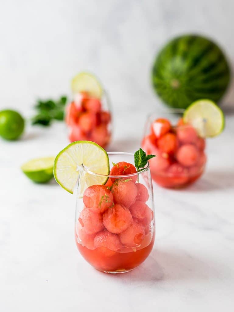 watermelon balls with lime and mint simple syrup in a clear glass cup