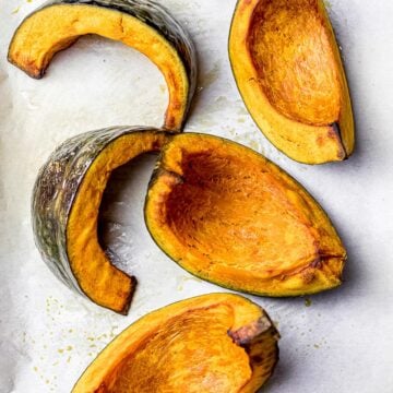 golden brown roasted kabocha squash wedges on parchment paper