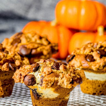 pumpkin chocolate chip muffins with cream cheese filling and streusel topping on a cooking rack