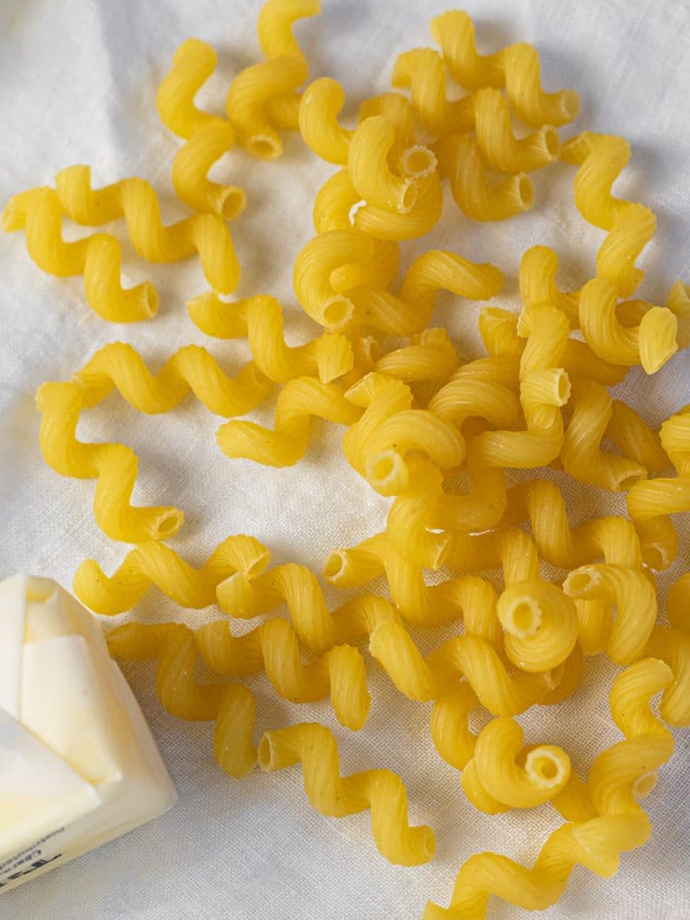 cavatappi pasta on a white background