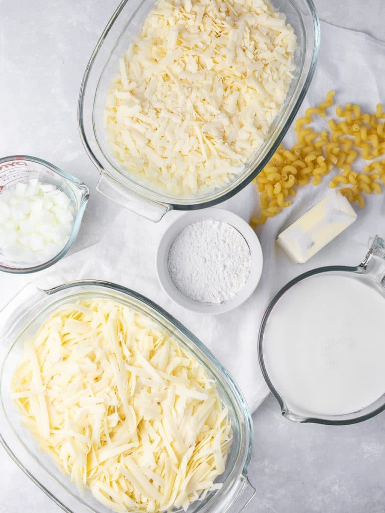 ingredients for mac and cheese including shredded cheese, butter, flour, and milk