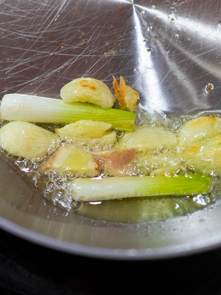 scallions, ginger, and garlic frying in oil