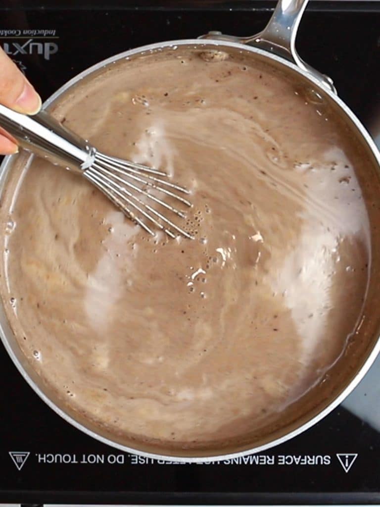 whisking hot chocolate in a pot