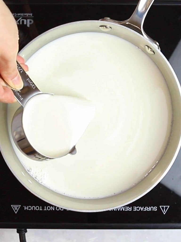 cream poured into a silver pot