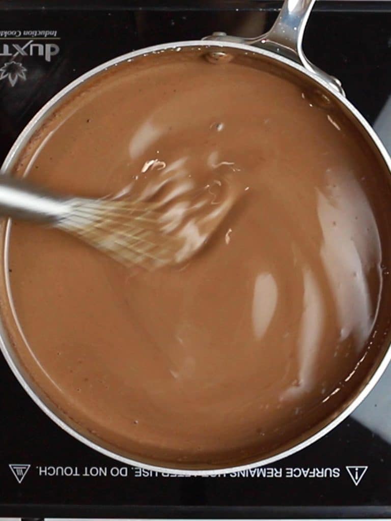 homemade hot chocolate heating in a pot