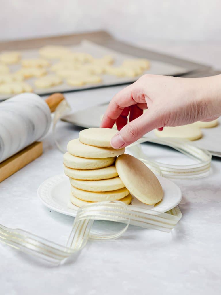 stack of soft cream cheese sugar cookies on a white plate