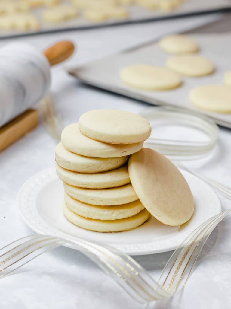 stack of soft cream cheese sugar cookies on a white plate