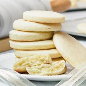 stack of soft cut out sugar cookies on a white plate