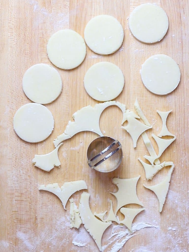 circle cut out sugar cookies on a wooden board