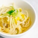 Korean soybean sprout side dish, kongnamul muchim, in a white bowl