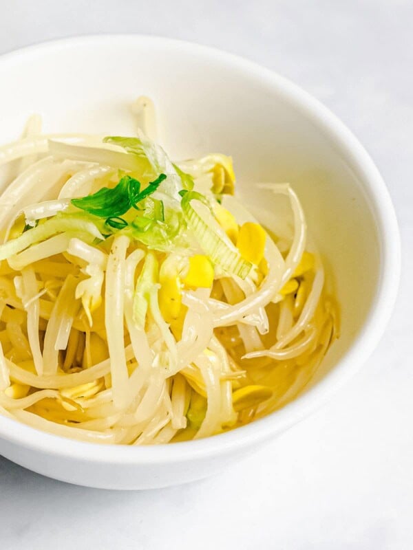 Korean soybean sprout side dish, kongnamul muchim, in a white bowl