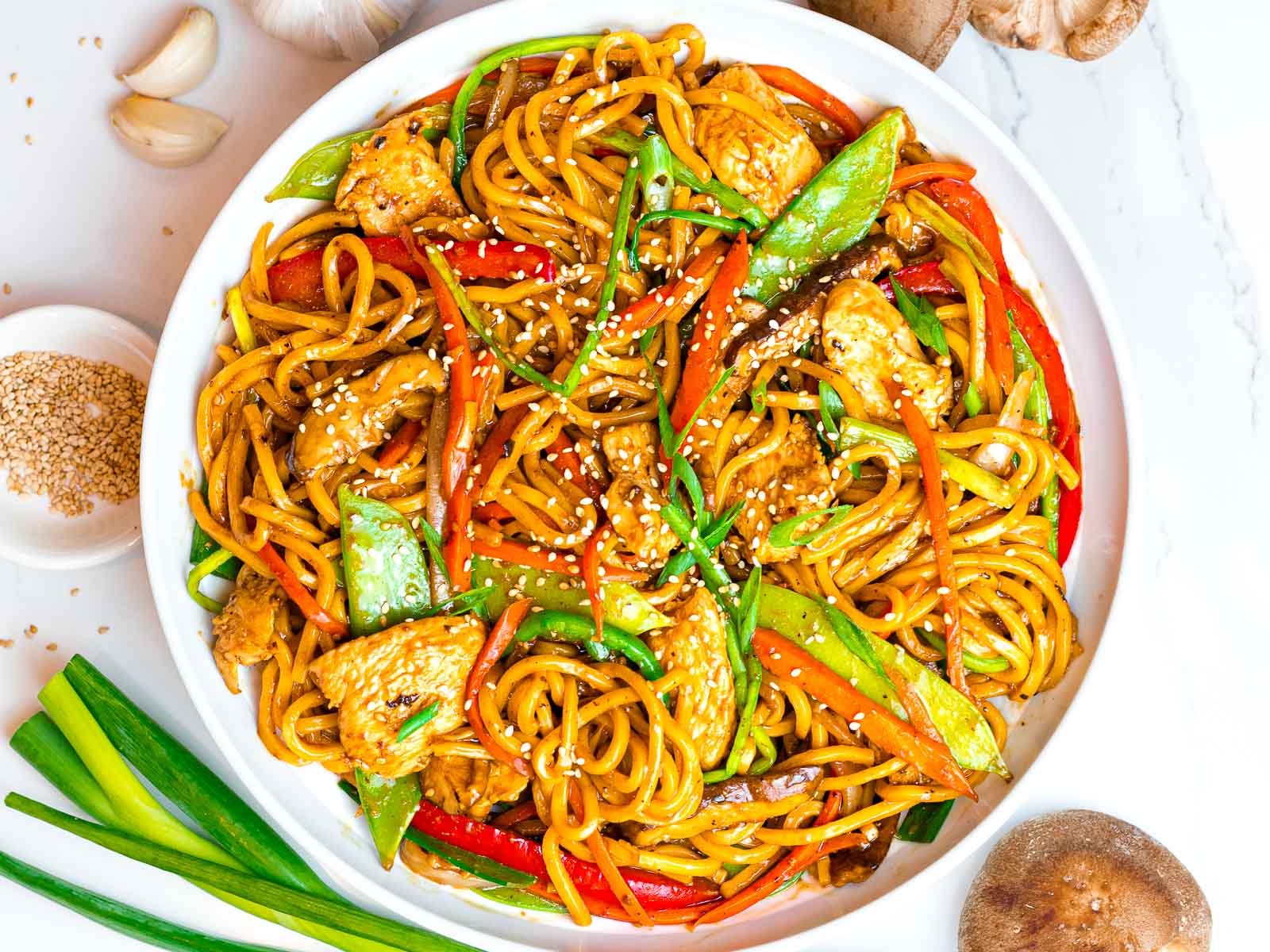 easy chicken lo mein with vegetables in a white bowl