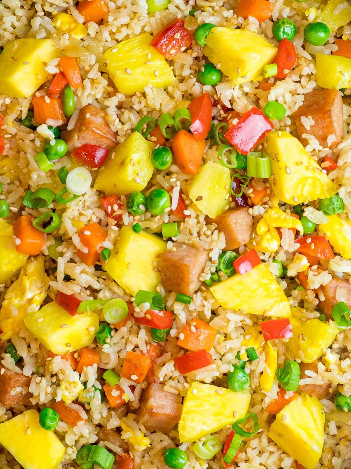 Hawaiian pineapple fried rice with pineapple chunks, red bell peppers, and peas