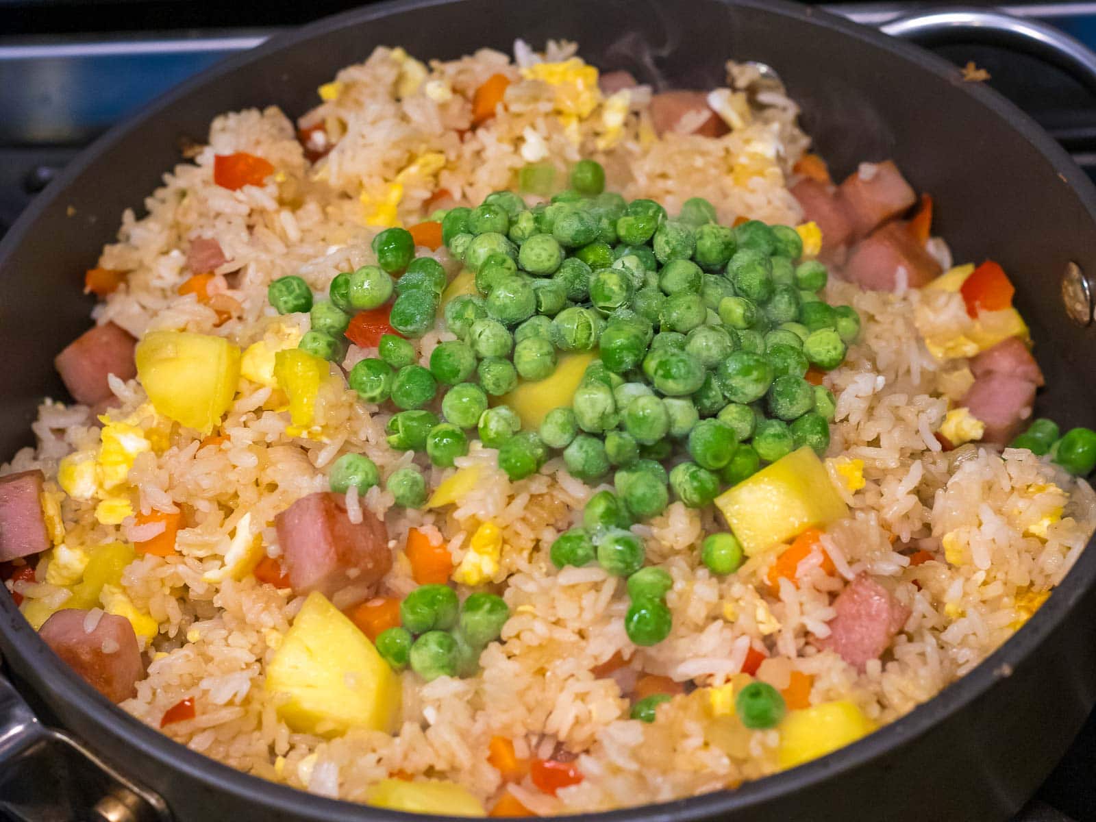 fried rice with pineapples and frozen peas