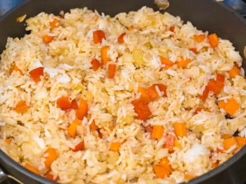 rice stir fried with carrots and red bell peppers with seasoning