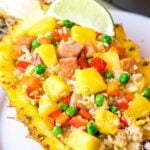 Pineapple fried rice with pineapples and ham served in a pineapple bowl