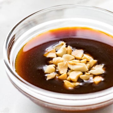 hoisin dipping sauce with crushed peanuts in a glass bowl