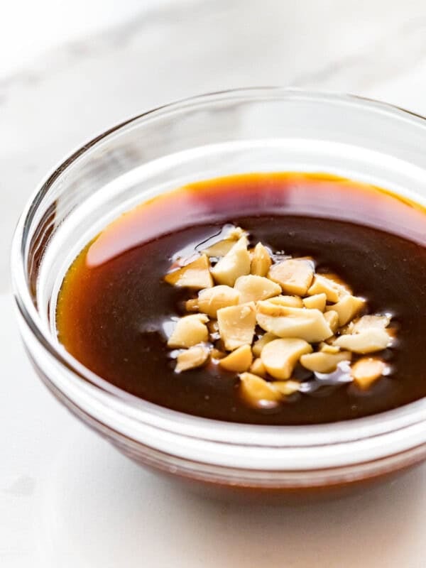 hoisin dipping sauce with crushed peanuts in a glass bowl