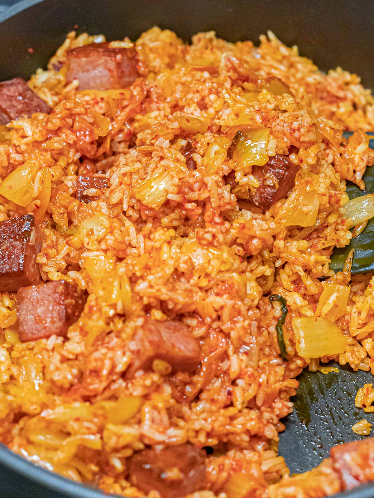 kimchi fried rice with cubes of spam in a pan