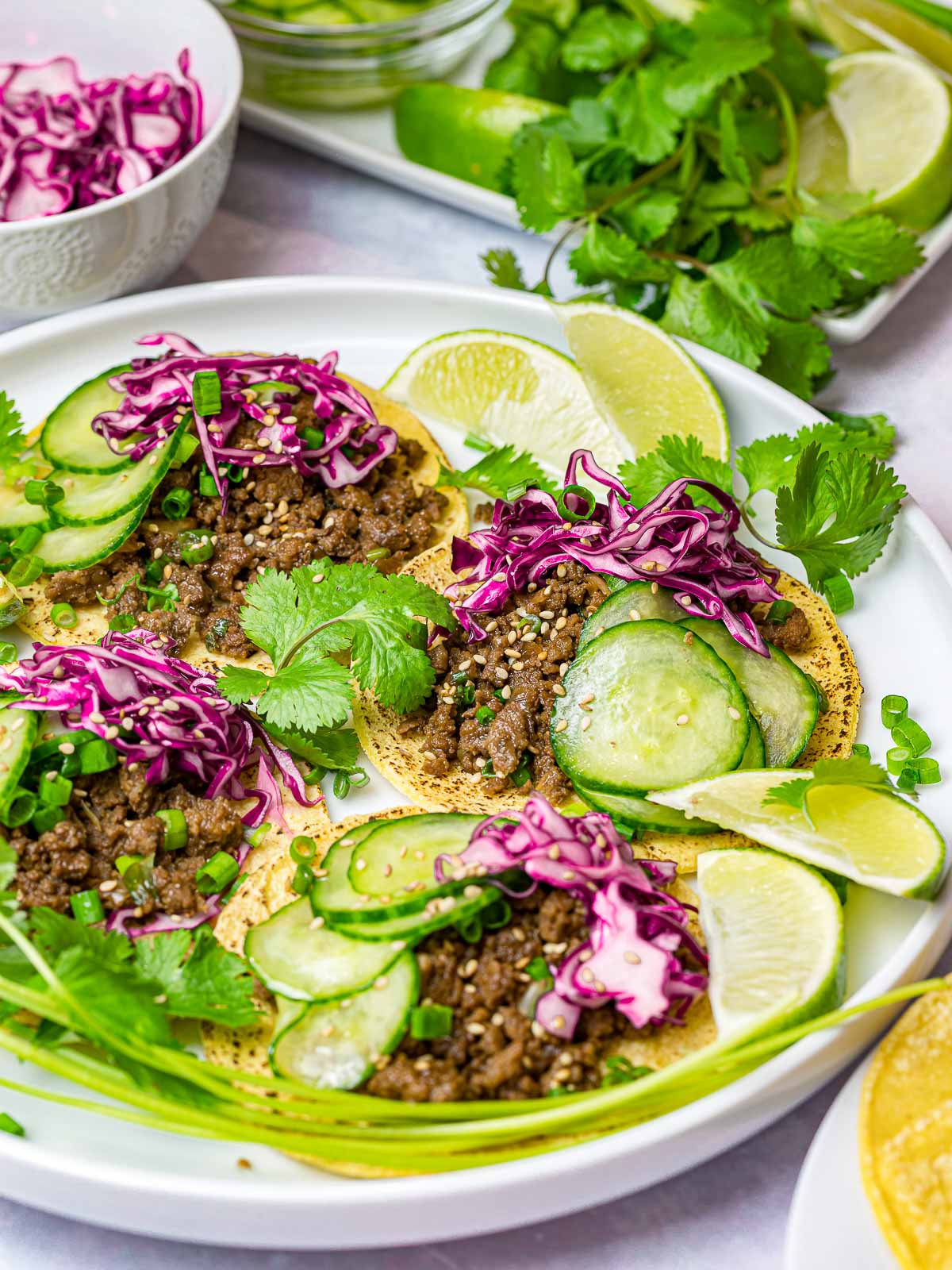 Korean bulgogi tacos with cabbage slaw and pickled cucumbers with lime