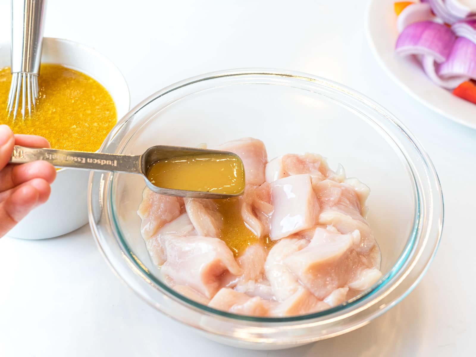pineapple marinade being added to chicken breast