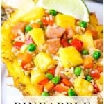 pineapple fried rice in a pineapple boat with a wedge of lime