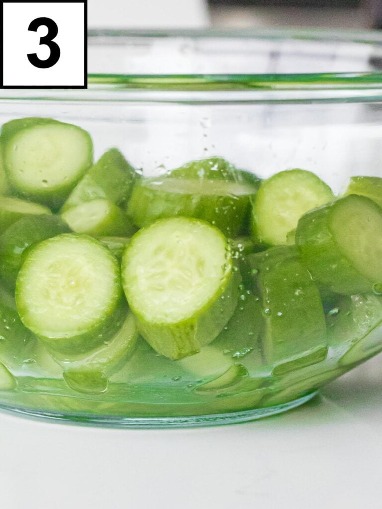 brined cucumbers pieces in a glass bowl