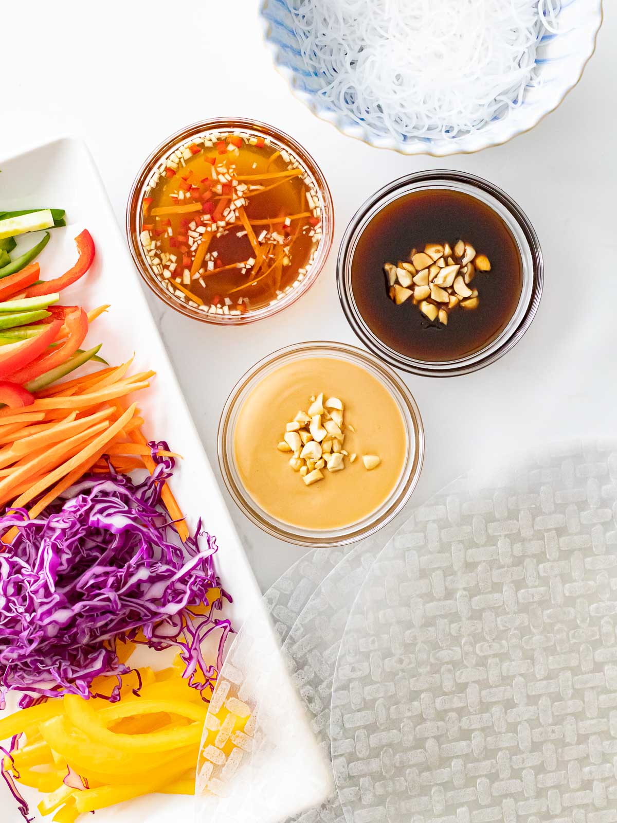 rainbow veggies with rice paper wrapper, dipping sauces, and vermicelli noodles