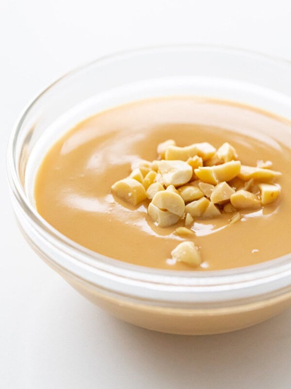 Vietnamese peanut sauce with crushed peanuts in a glass bowl