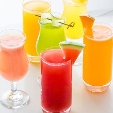 close up of aguas frescas flavors including watermelon, cucumber, mango, pineapple, and cantaloupe