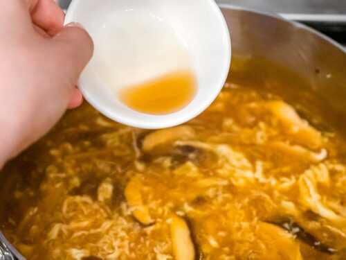 sesame oil being added to hot and sour soup